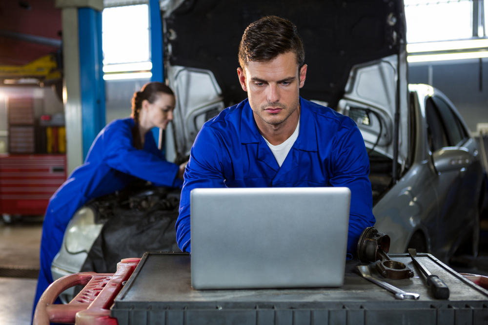Fleet manager reviewing maintenance software on a tablet