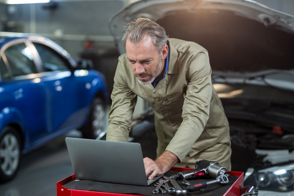Technician inspecting a vehicle during a maintenance service